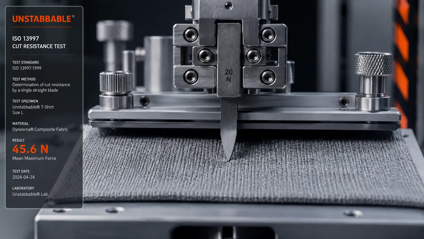 An ISO 13997 cut resistance test: a straight blade in a steel test rig cutting into a fabric sample.